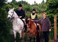 Riders emerge from woodland track
